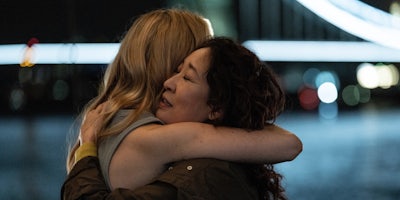 jodie comer (left) and sandra oh (right) hugging in killing eve