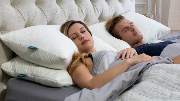 Woman and man asleep in bed