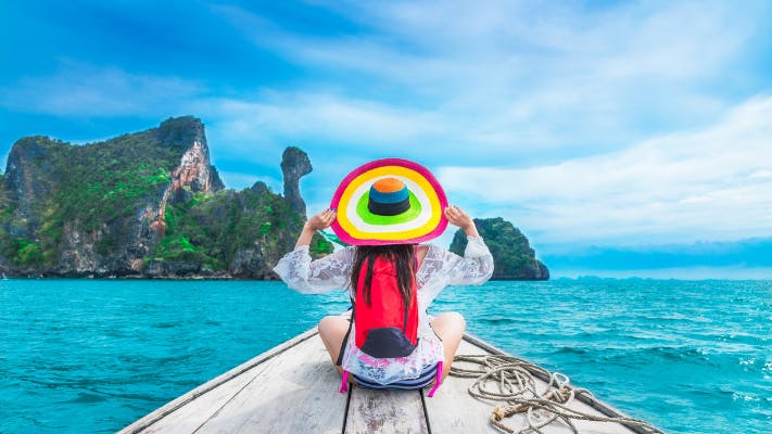 Summer lifestyle traveler woman in bikini and big hat joy relaxing on boat,