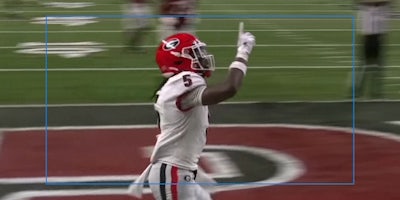 Adonai Mitchell raises finger in end zone wearing Georgia Bulldogs helmet
