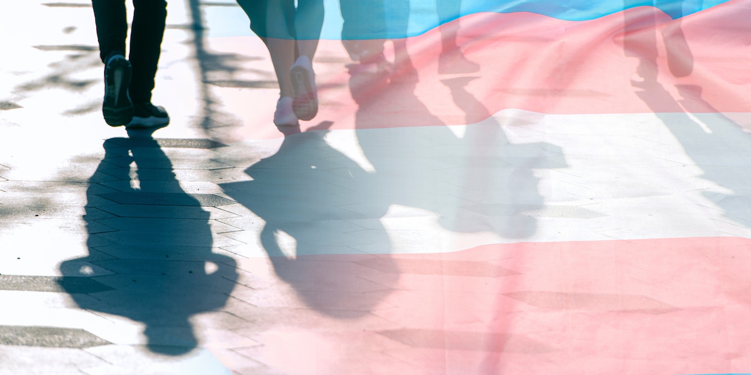 Transgender flag, shadows and silhouettes of people on a road, conceptual picture about anonymous Transgender and Gay Lesbian in the World