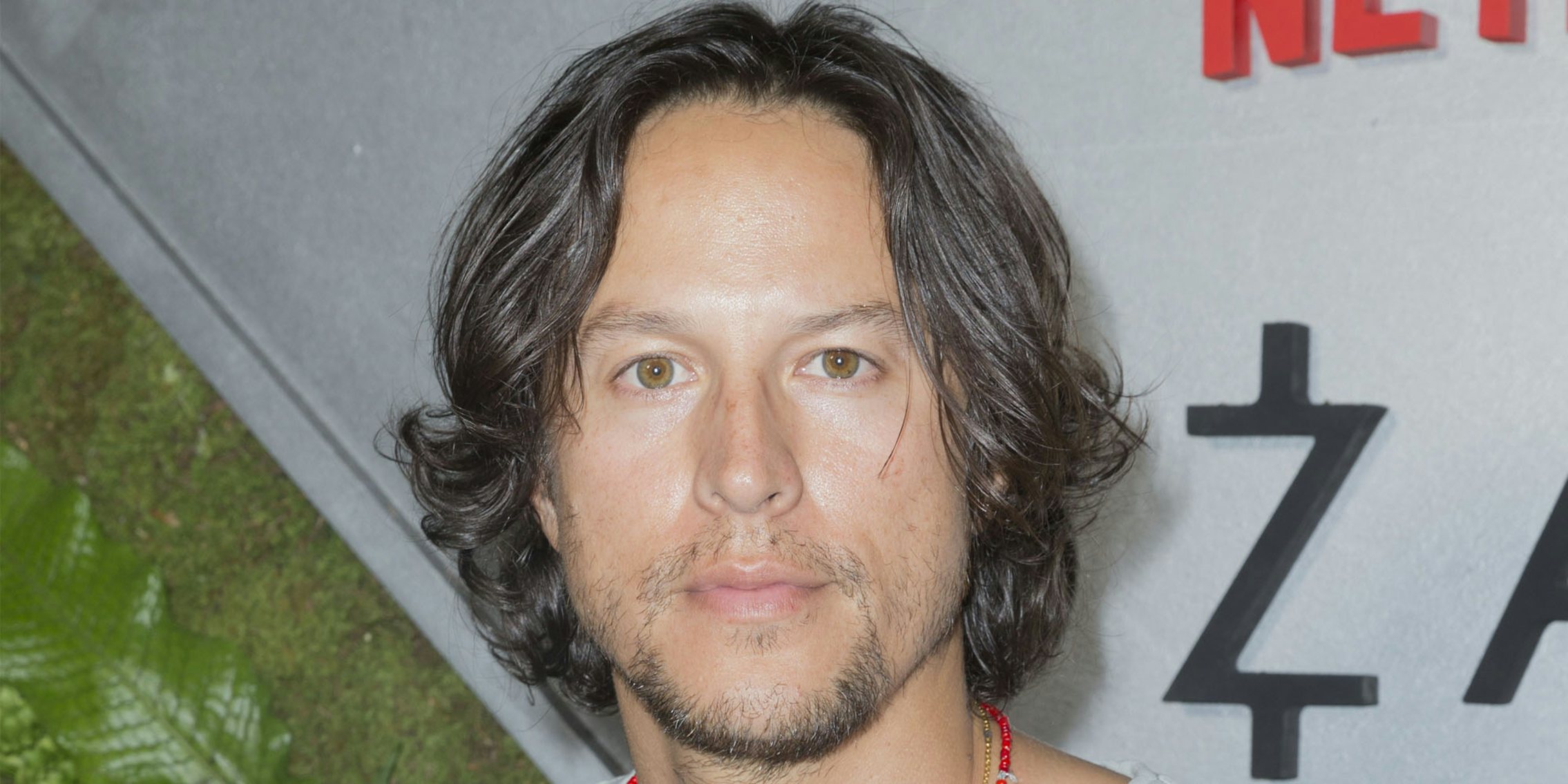 Cary Fukunaga on white and green background