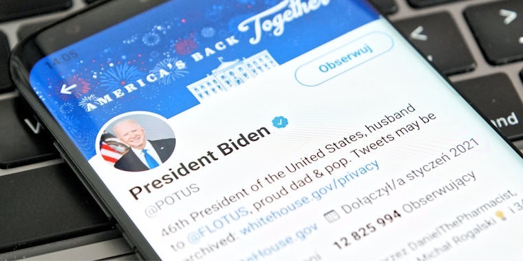 President Joe Biden Twitter account on phone on computer keyboard 'President Biden @POTUS 46th President of the United States, husband to @FLOTUS, proud dad & pop. Tweets may be archived'