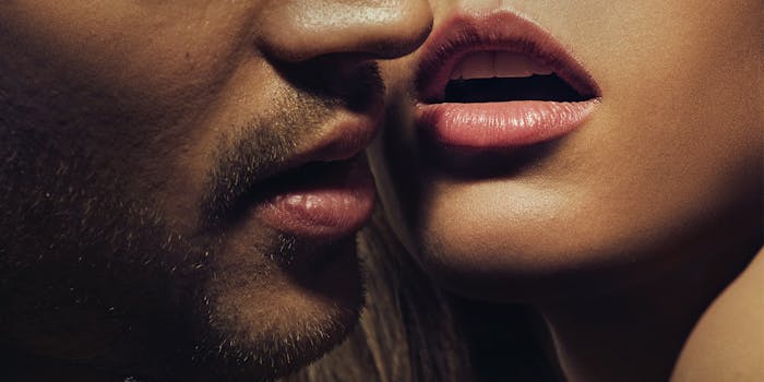 Man with beard mouth next to woman's mouth both mouths open