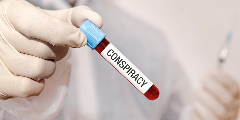 lab technician holding a vial that says 'conspiracy' on it