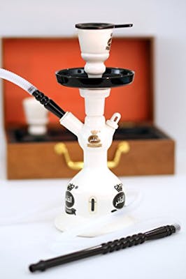 White ceramic hookah sitting in front of red and brown wooden box.