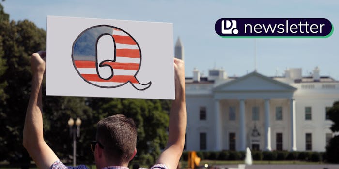 A man holding a QAnon sign in Washington D.C. The Daily Dot newsletter logo is in the top right corner.
