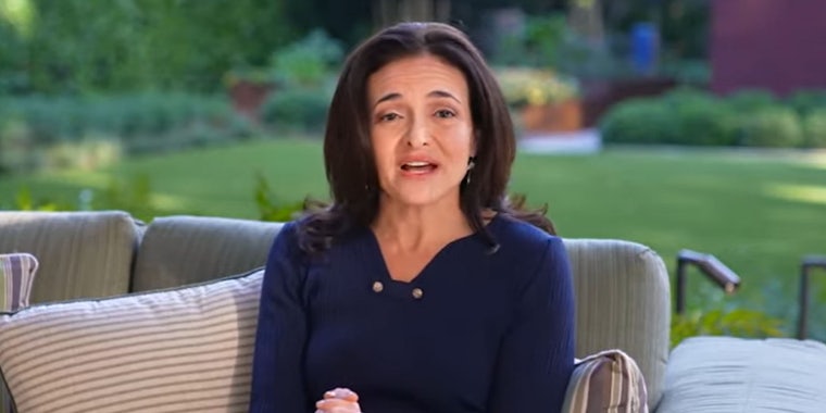 Sheryl Sandberg speaking in chair outside
