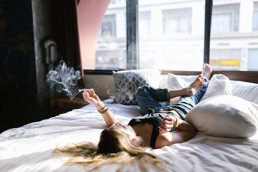 Woman on bed smoking a joint.