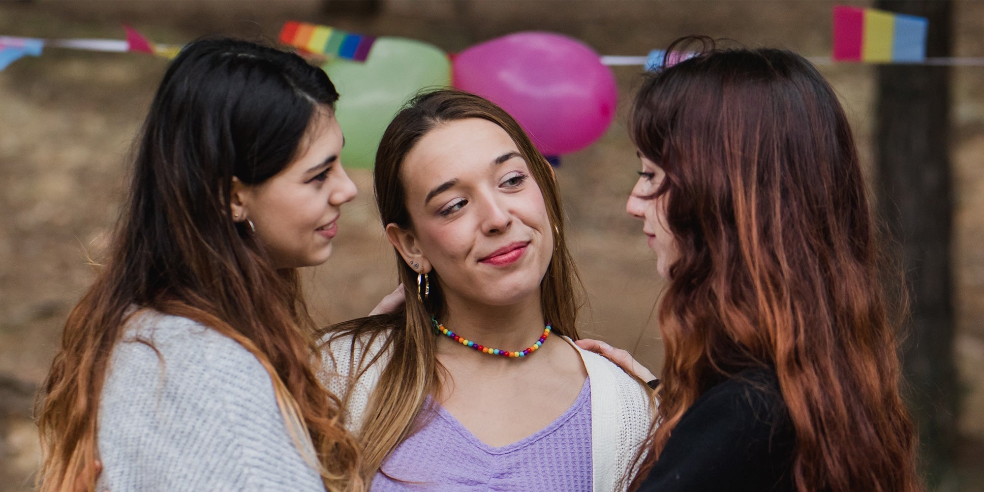 women in polyamory relationship diversity flags in background