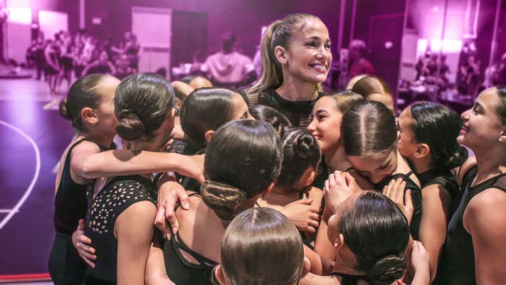 jennifer lopez (center) surrounded by young dancers in halftime