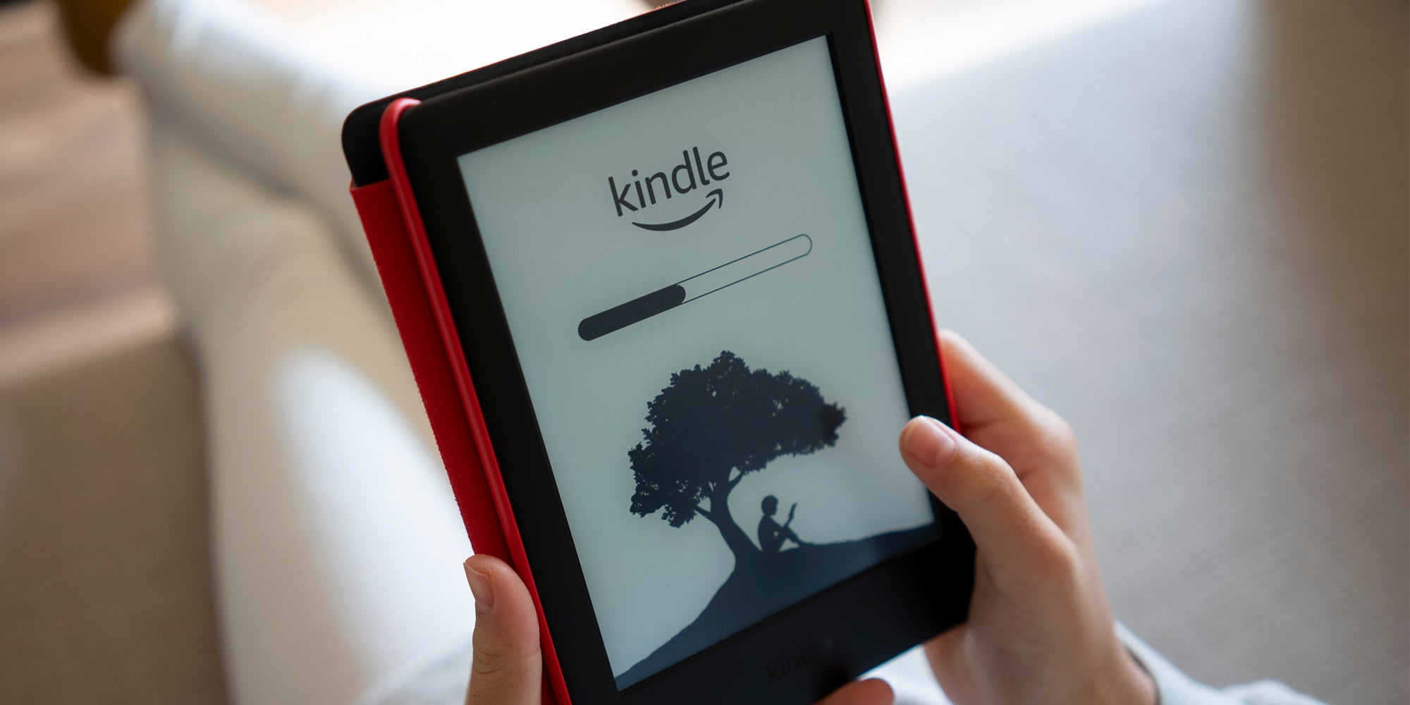 hands holding kindle