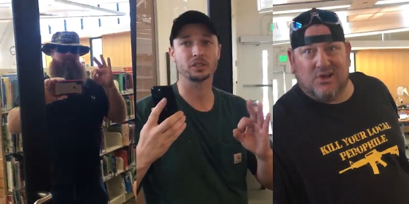 men in library making white supremacists hand gestures
