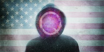 QAnon conspiracy theory concept. Of a hooded figure with the Q symbol. Over layered with the United States flag. with a blurred, grunge, abstract edit
