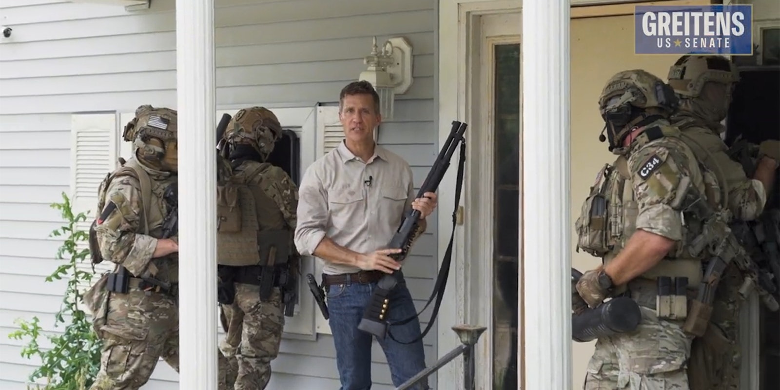 men with weapons on porch preparing to breach door with 'Greitens US SENATE' logo