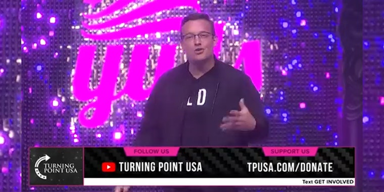 man on stage with 'Turning Point USA' overlay