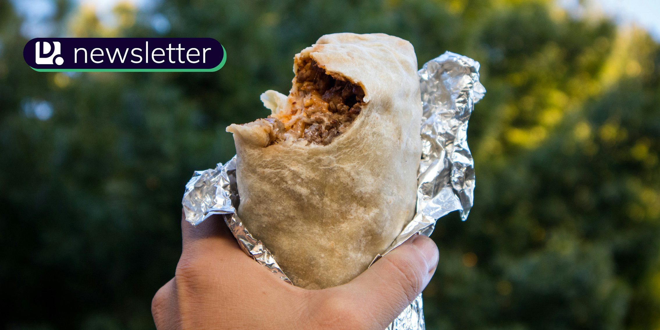 A hand holding a burrito. The Daily Dot newsletter logo is in the top left corner.