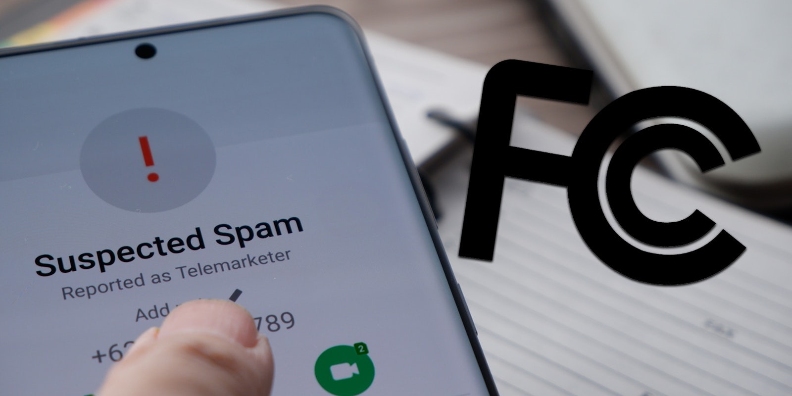 hand holding phone 'Suspected Spam' incoming call with FCC logo on right