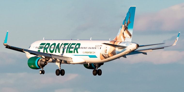 Frontier airplane flying in sky