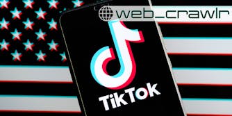 A phone showing the TikTok logo in front of an American flag. The Daily Dot newsletter web_crawlr logo is in the top right corner.