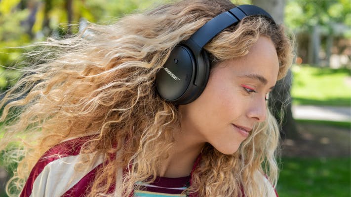 Woman hearing Bose headphones