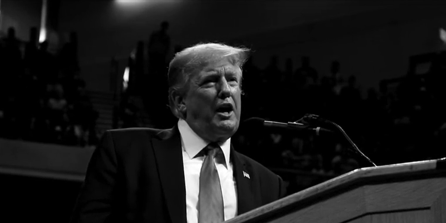 Donald Trump speaking in microphone in black and white