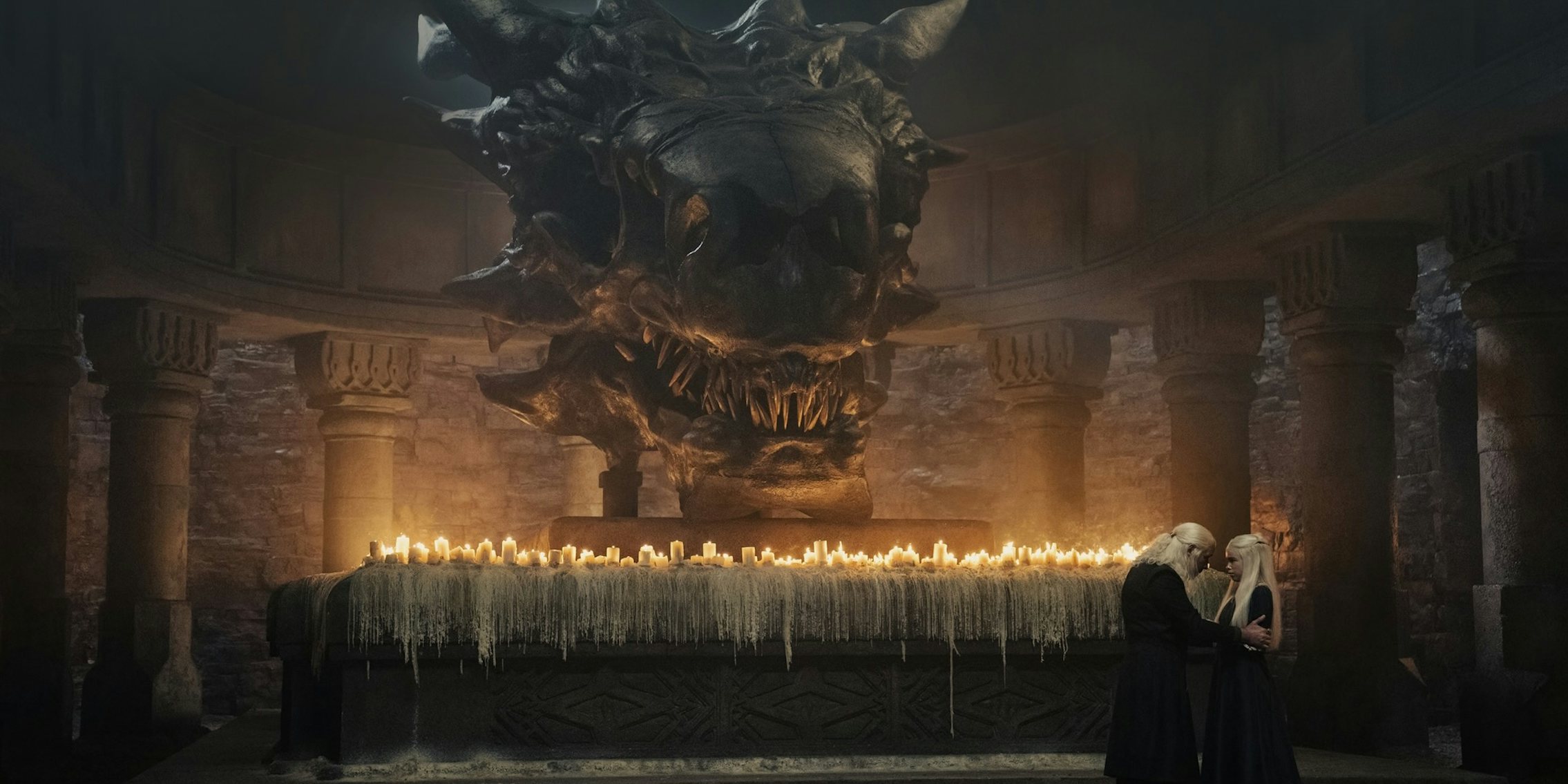 viserys (left) and rhaenyra (right) stand near balerion's skull in house of the dragon