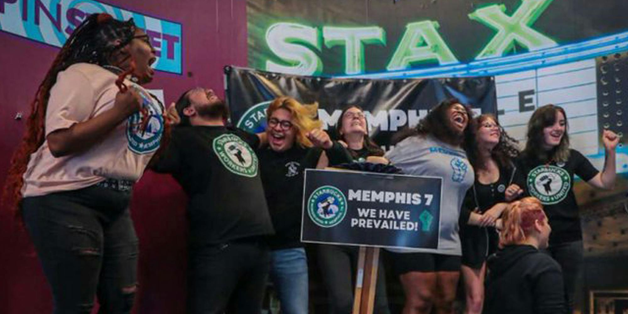 7 Memphis organizers celebrating next to sign ''MEMPHIS 7 WE HAVE PREVAILED!"
