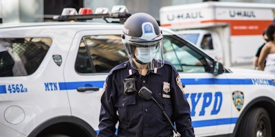 ner york police officer wearing mask and shield