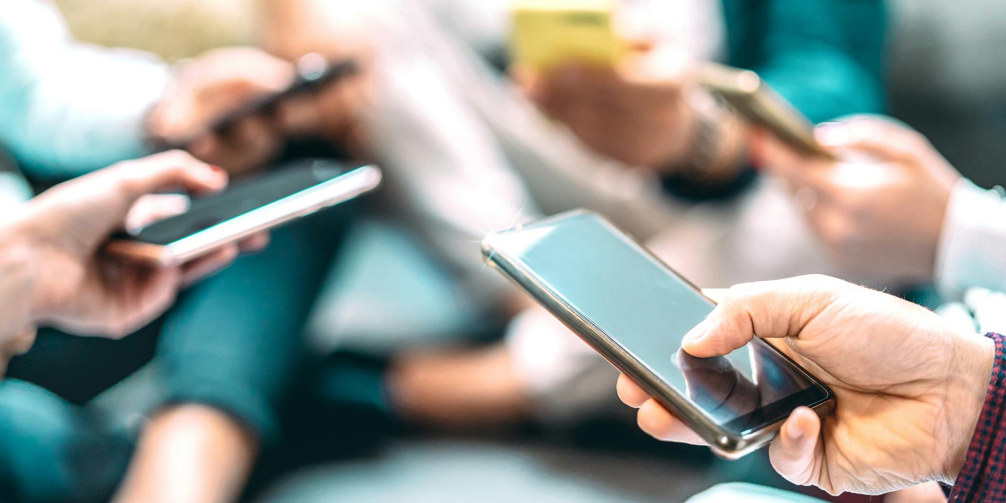 group of people using smartphones