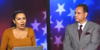 Real America voice anchors speaking on red and blue background with stars