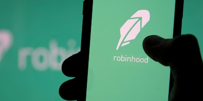 hand holding phone with Robinhood app