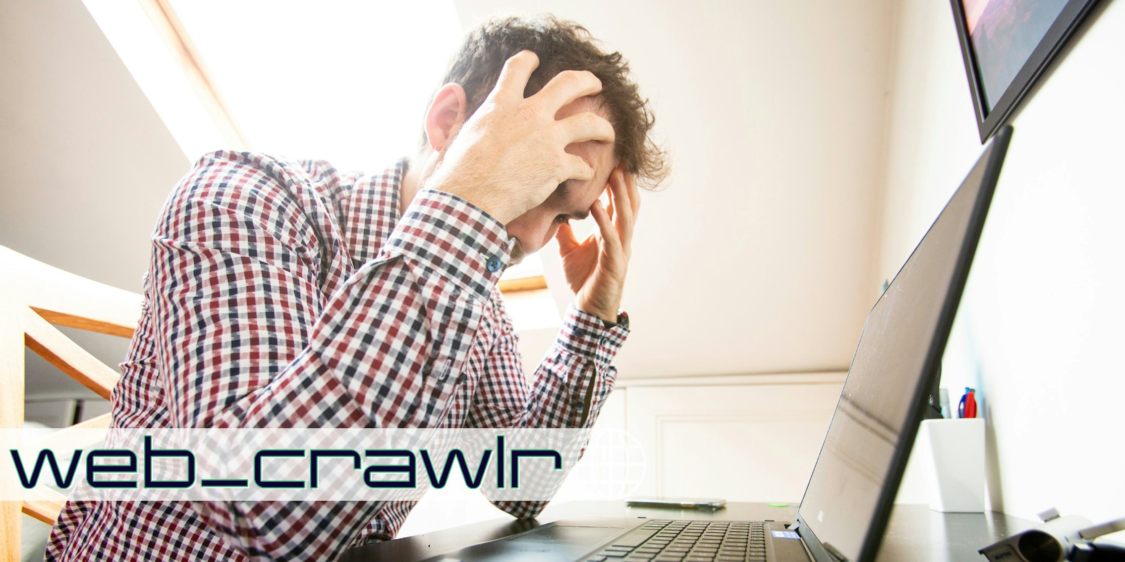 A person looking frustrated in front of a laptop. The Daily Dot newsletter web_crawlr logo is in the bottom left corner.