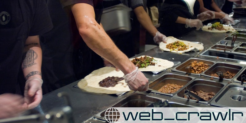 Workers prepare burritos at a Chipotle Mexican Grill in Midtown in New York. The Daily Dot newsletter web_crawlr logo is in the bottom right corner.