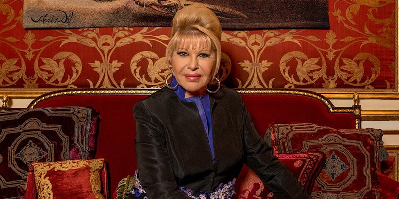 Ivana Trump sitting on red couch with red wall and painting behind her