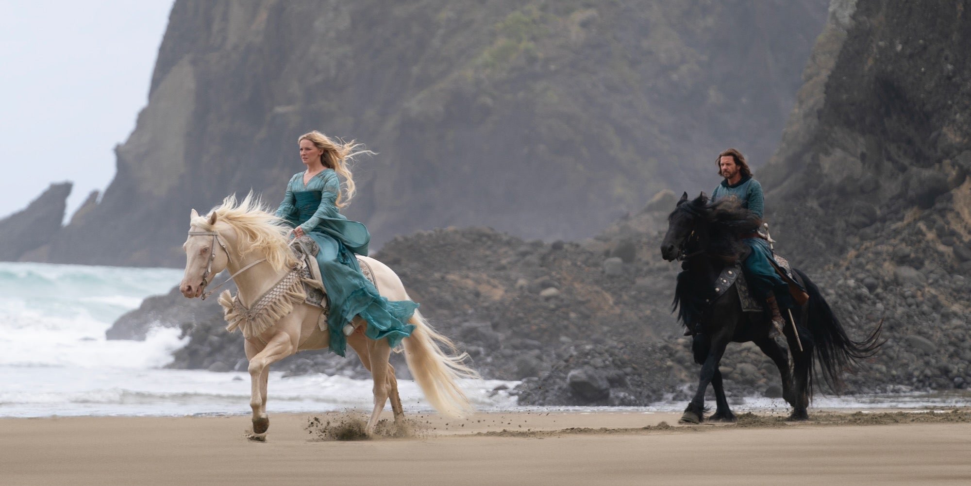 galadriel (left) and elendil (right) riding horses in númenor in the rings of power