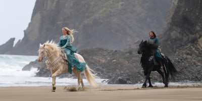 galadriel (left) and elendil (right) riding horses in númenor in the rings of power