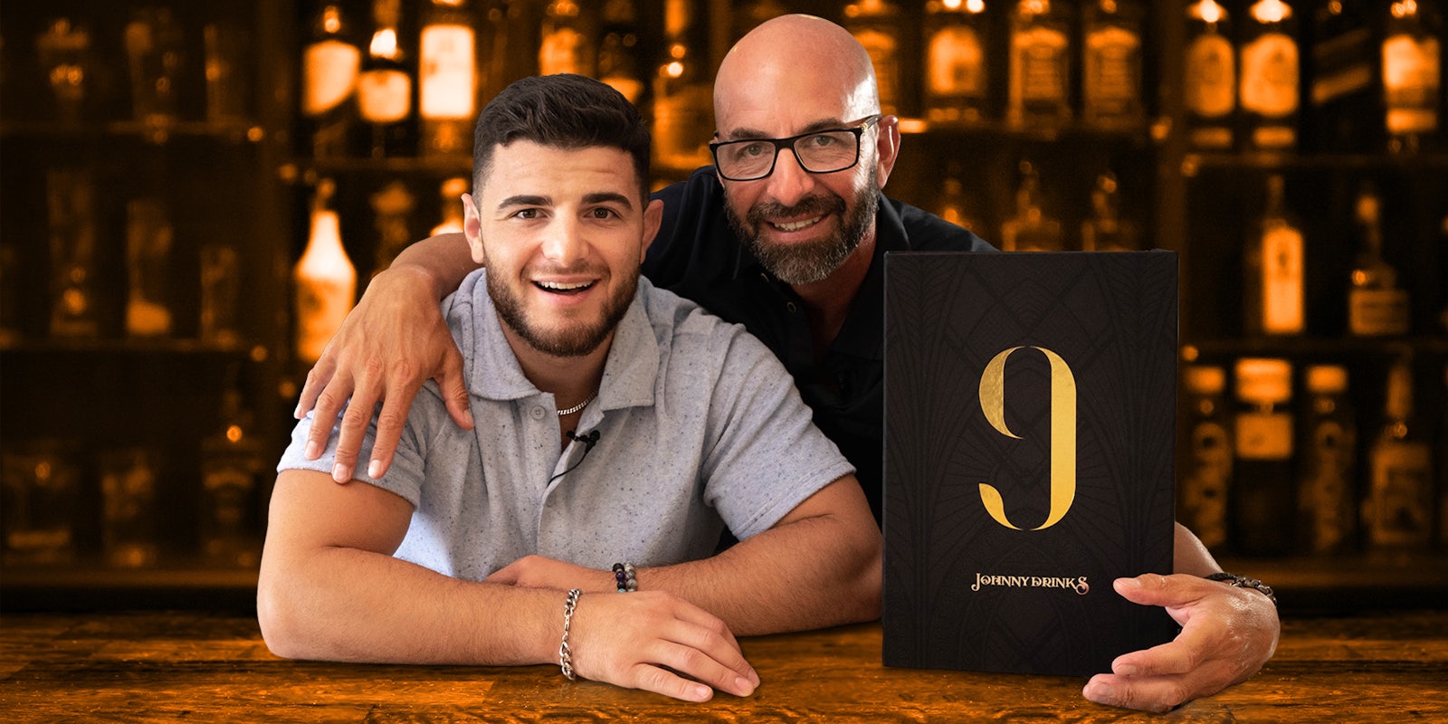 Two men at a bar with a plaque that reads '9 Johnny Drinks'