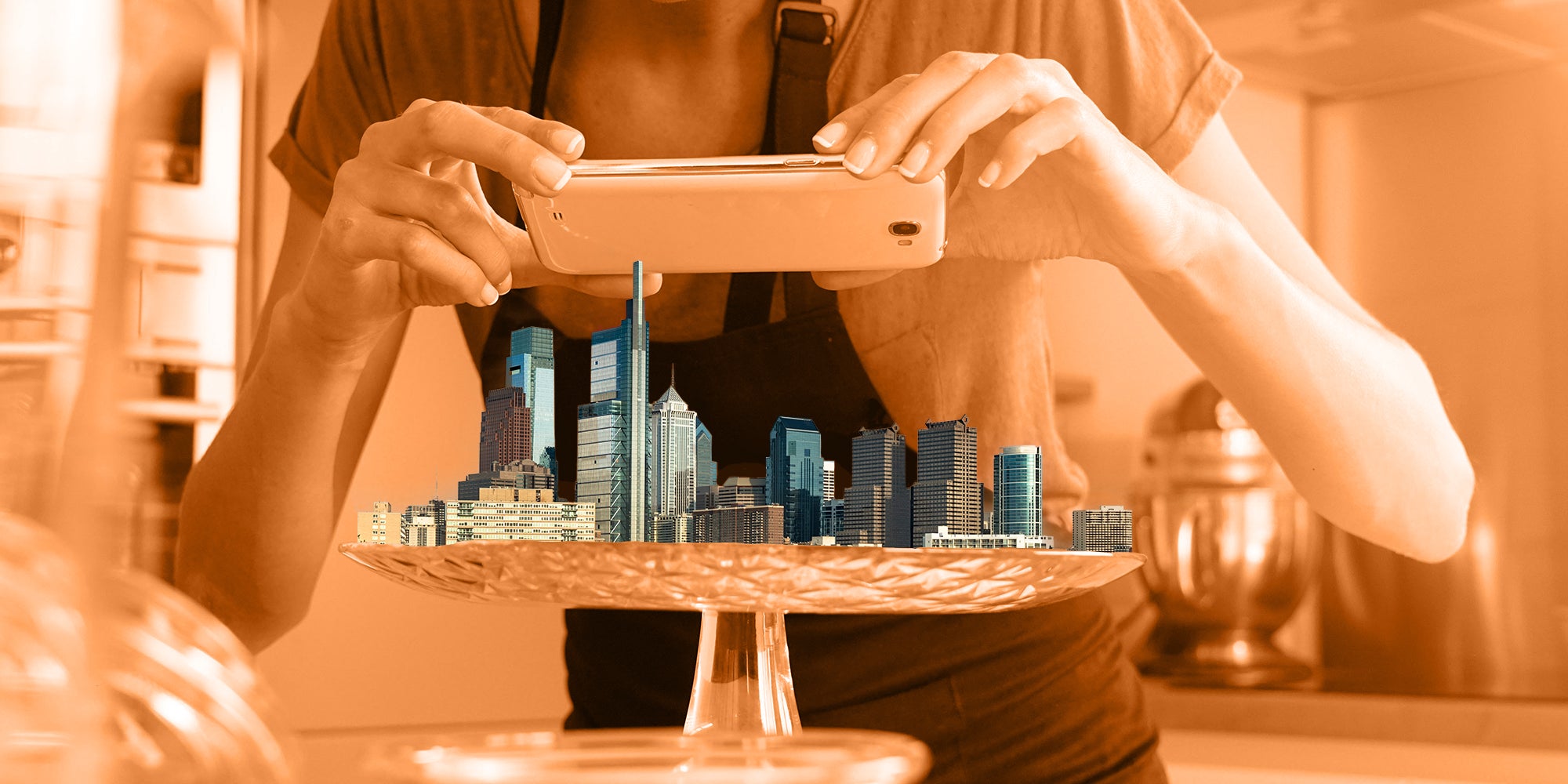 Blogger taking picture of Philadelphia skyling on platter