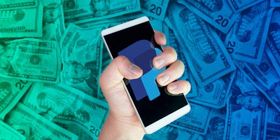 hand holding phone with PayPal logo on screen over green to blue horizontal gradient money background