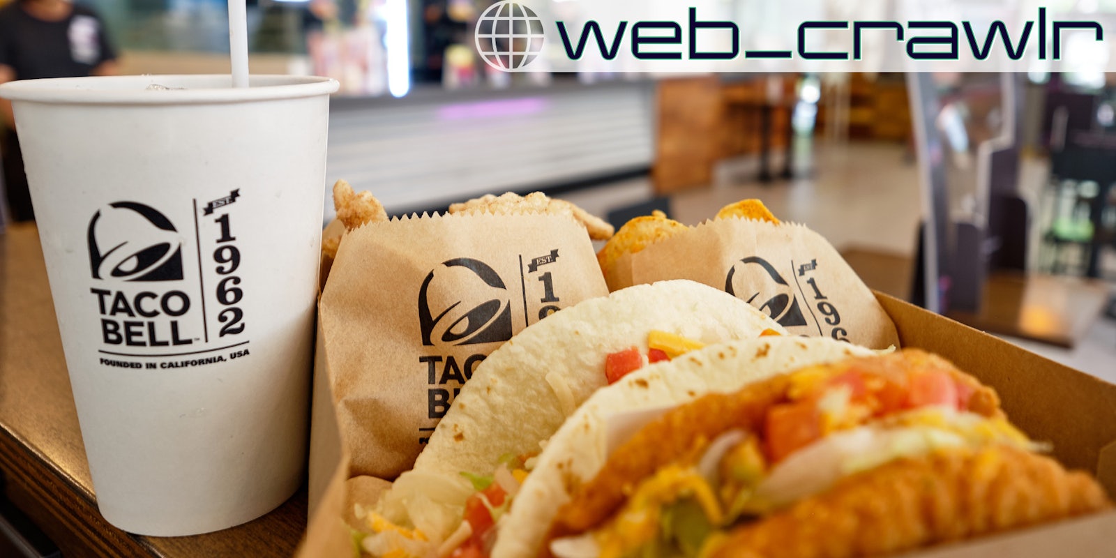 A Taco Bell meal on a table. The Daily Dot newsletter web_crawlr logo is in the top right corner.