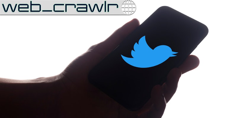 A hand holding a smartphone with the Twitter logo on it. The Daily Dot newsletter web_crawlr logo is in the top left corner.