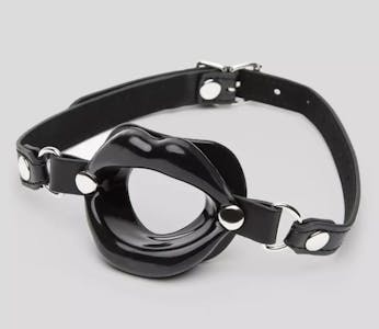 The Dominix deluxe silicone open mouth gag, featuring black open lips, against a grey background.