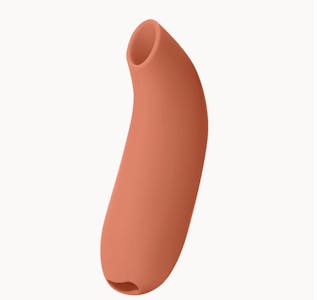 A melon-colored Dame Aer clitoral suction toy against an off-white background.