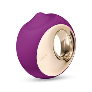 best quiet vibrator - A circular plum-colored Lelo Ora 3 vibrator with gold inlay.