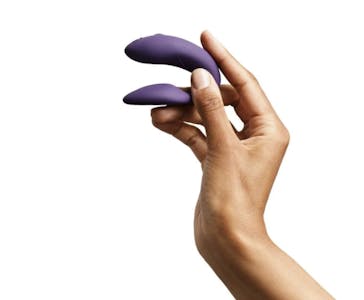 best quiet vibrator - A hand holding a purple clip-shaped We-Vibe Chorus vibrator.