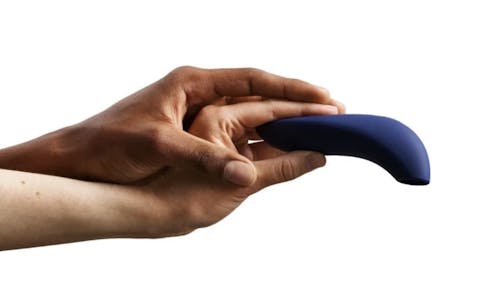 Two different left hands holding a blue We-Vibe Melt vibrator.