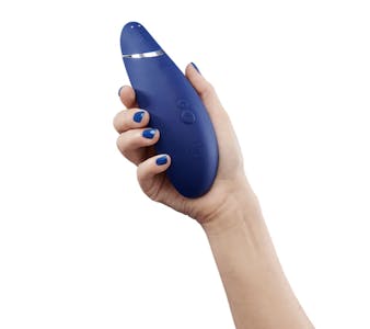 best quiet vibrator - A woman's hand holding the wave-shaped Womanizer Premium 2 vibrator.