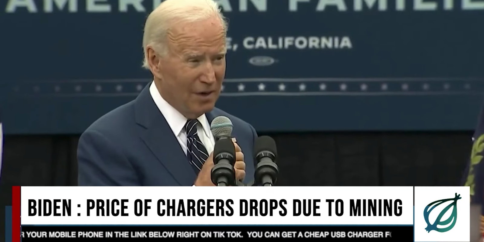 President Joe Biden holding a microphone and giving a speech