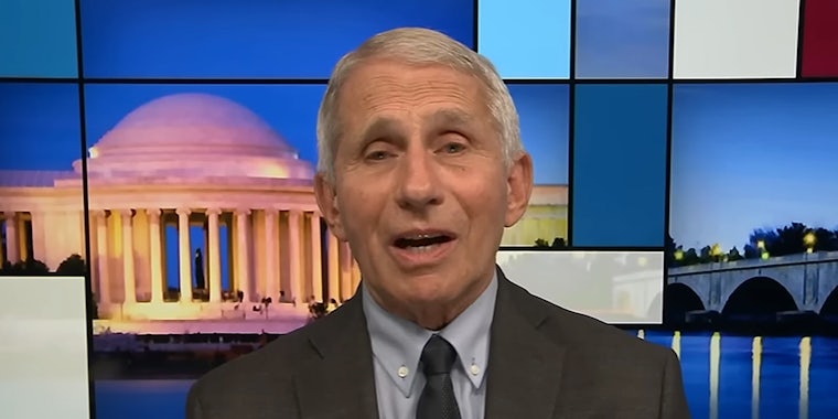 Dr. Anthony Fauci speaking in front of blue background